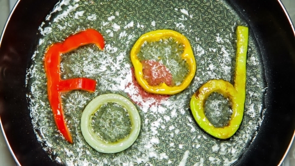 Frying Wok With Slices Of Vegetable Letters Being