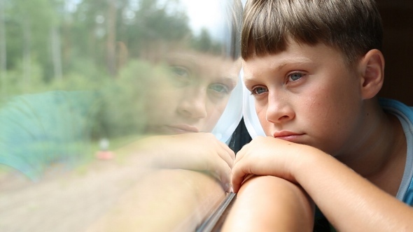 Sad Boy Rides in a Train alt