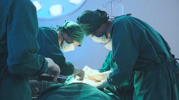 asian coworker Medical Team Performing Surgical  performing an operation alt