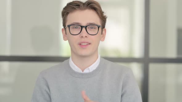 Portrait of Young Man Talking on Online Video Call alt