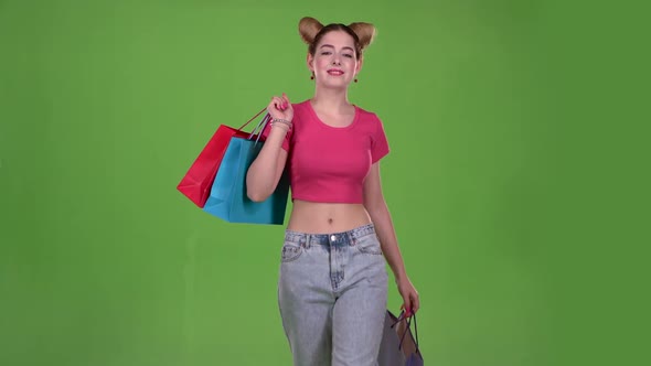 Girl Goes Shopping with Bags in His Hands. Green Screen. Slow Motion alt