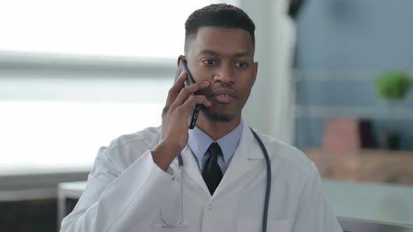 Portrait of African Doctor Talking on Smartphone alt