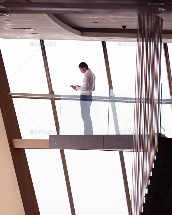 young successful business man in penthouse apartment working on - Stock Photo - Images