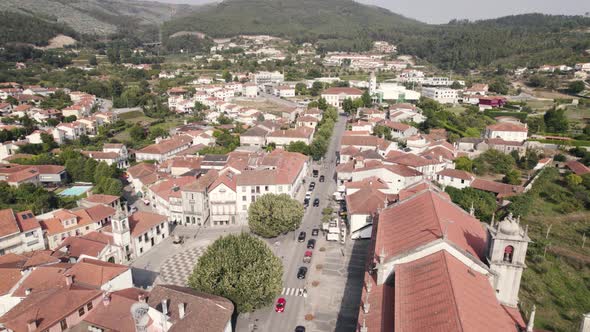 Beautiful rooftops of Arouca town surrounded by mountain range, aerial drone view alt