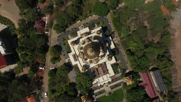 Top down rotating Aerial view of Buu Long Pagoda, a beautiful Buddhist temple with large gold roof s alt