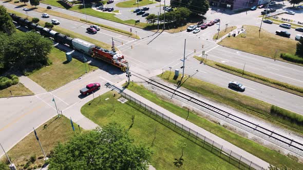 Pan follow of a train making its way through the tracks near downtown Muskegon in Michigan. alt