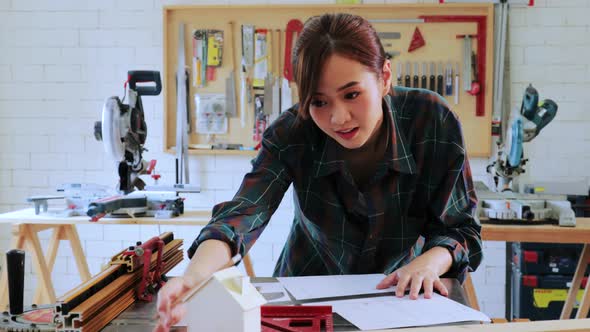 Carpenter student woman design wood construction on workshop table in workshop university