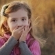 Little Girl In a Sunset Light Blows a Kiss To The - VideoHive Item for Sale