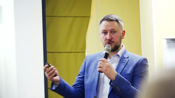 Speaker on the podium. People at the conference hall. alt