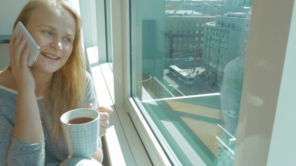 Woman Having Phone Talk And Drinking Tea alt