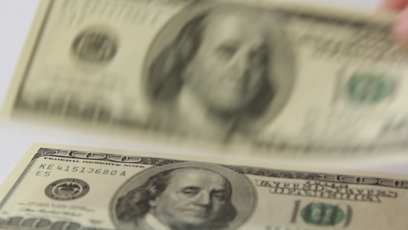 One Hundred Dollar Bills  a White Background. 