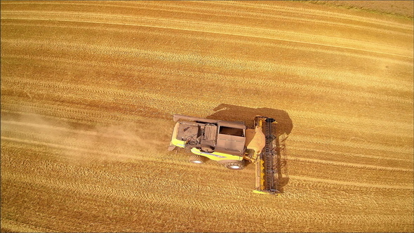 Top View of the Yellow Harvester Running on the Field