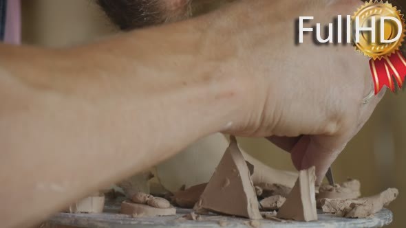 Male Potter Craftsman is Making a Clay alt