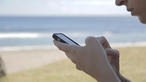 Using Mobile Phone On Beach