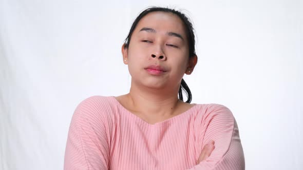 Asian woman thinking and looking up on white background in studio. alt
