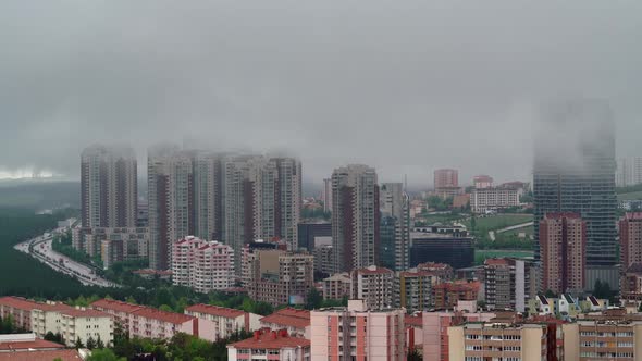 8K Low Clouds Mixed With Fog on Skyscrapers of Modern Urban City