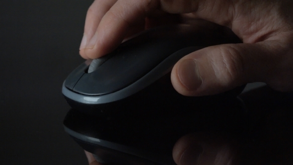 Male Hand Clicking And Moving Computer Mouse