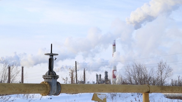 Large Valve of the Gas Pipe, the Smoke Comes from the Chimneys alt