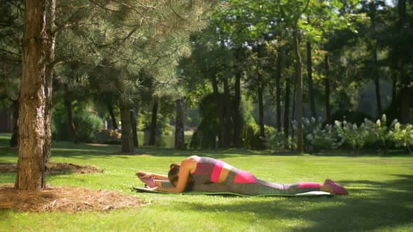 Active Woman Doing Stretching Exercises in Park alt