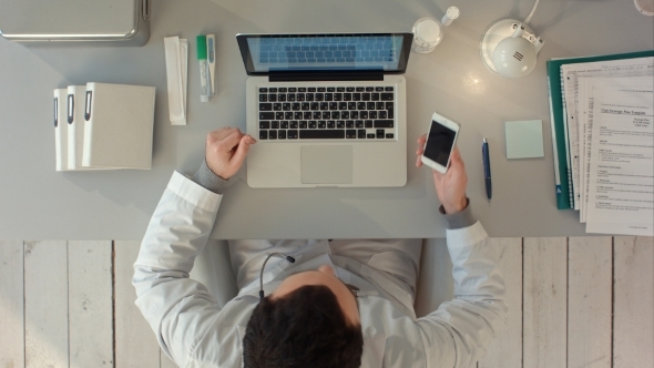 Doctor Having a Happy Conversation On Phone Mobile alt