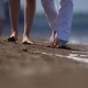 Guy and Girl are Walking on the Sand - VideoHive Item for Sale