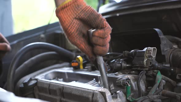 auto mechanic repairs sedan auto. close-up alt