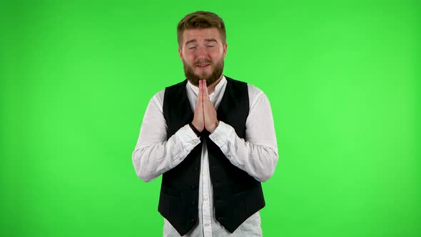 Man Keeps Palm Together and Asks for Something Isolated. Green Screen alt