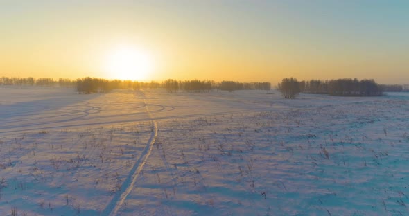 Aerial Drone View of Cold Winter Landscape with Arctic Field, Trees Covered with Frost Snow and alt