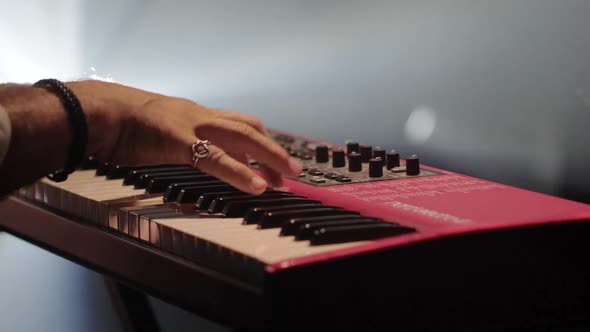 Male Hands Playing on Synthesizer Piano alt