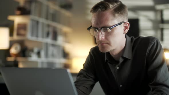 Young Man Freelancer Using Laptop Online Working From Office In Internet, Smiling Focused Millennial