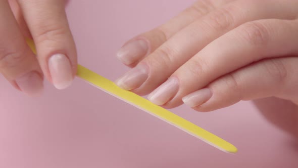 Woman Hand on Pink Makes Manicure for Herself