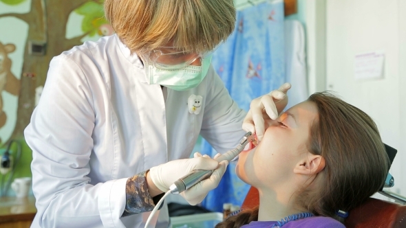 Orthodontist Cleaning Girl Patient Teeth