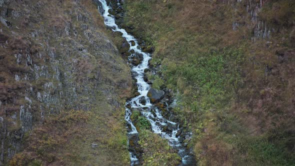 Narrow mountain waterfall