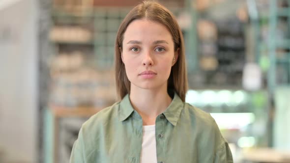Portrait of Serious Woman Looking at Camera alt