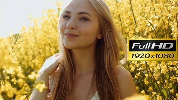 Smiling Cute Girl Between Yellow Flowers alt