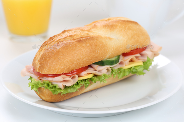 Sub deli sandwich baguette for breakfast with ham and orange juice