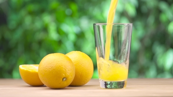Fresh Orange Juice Pouring Into Glass 