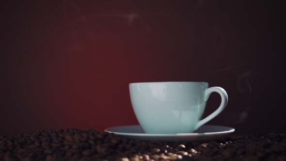 Cup Of Hot Coffee With Steam On a Dark Background