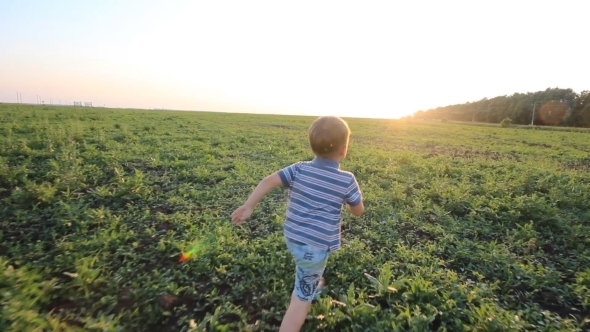 Boy Running Across Hill alt