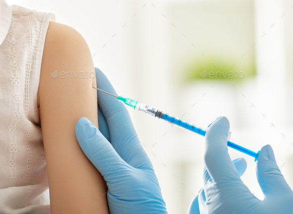 a vaccination to a child - Stock Photo - Images