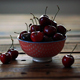 Red Ripe Cherries In Small Bowl On Wooden Table - VideoHive Item for Sale
