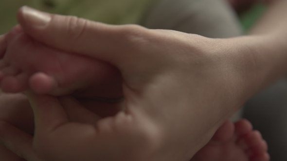 Mom Hands Foot Massage Her Baby alt