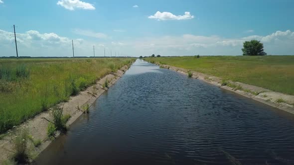 Irrigation Channel in Agricultural Field, Flying Shot Over Water, Aerial View