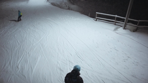 Aerial Shot The Snowboarders Slide Down The Mountain alt