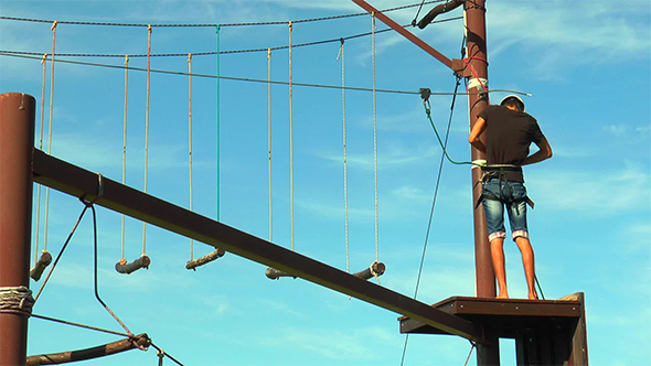 Man Fixes a Safety Rope Rope Park