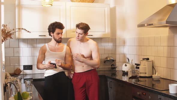 Two Young Sexy Guys in the Kitchen. Love and Relationships. alt