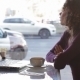 Cute Girl Drinking Coffee On a Cafe In The City - VideoHive Item for Sale