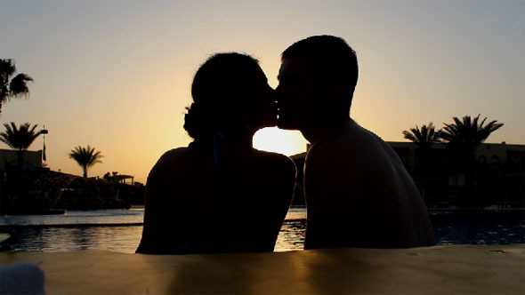 Lovers Are Kissing and Enjoying The Sunset