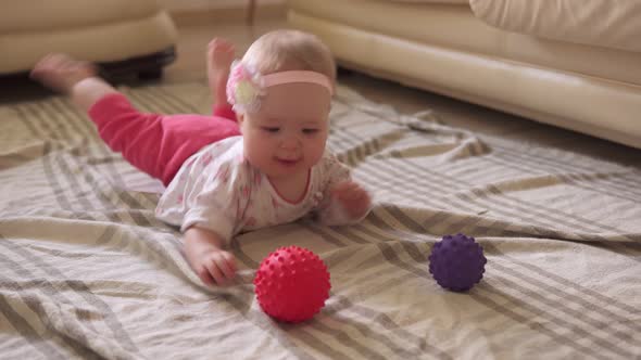 Toddler Funny Playing with Toy Ball on Floor