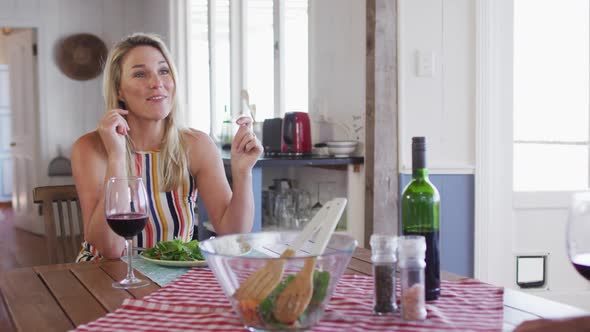 Happy caucasian mature couple smiling, talking and enjoying meal together alt